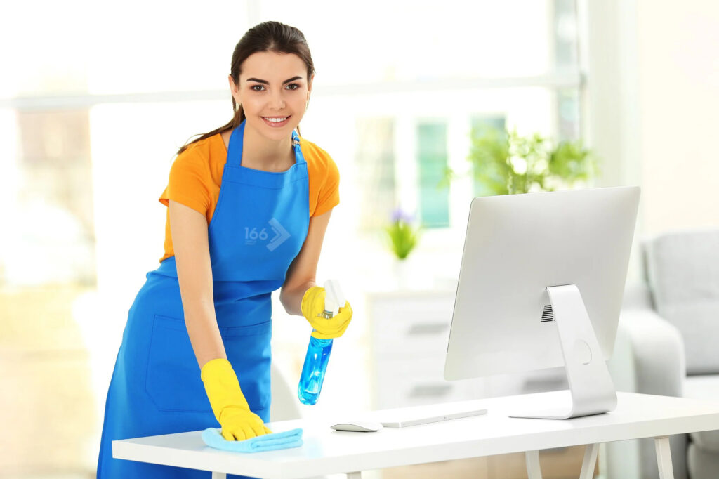 Cupertino CA cleaning staff wiping office desk with spray bottle