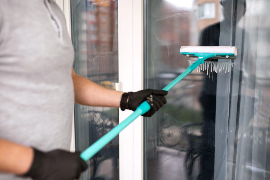 Window squeegee cleaning glass door in Cupertino CA home