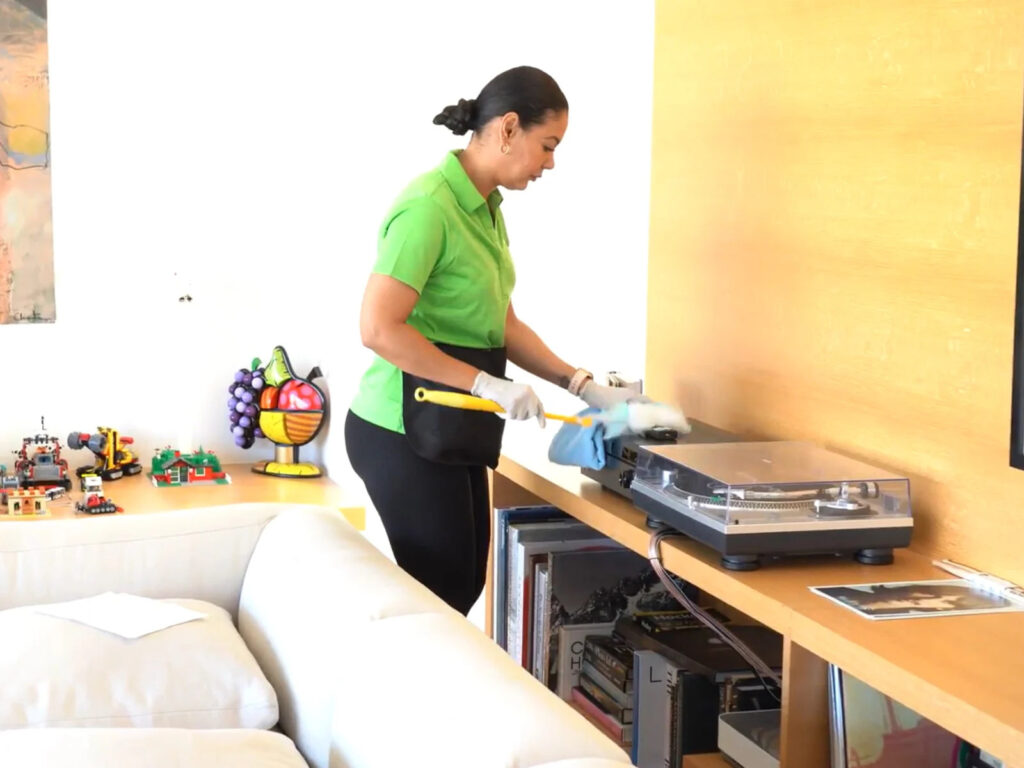 Home cleaning technician dusting electronics in Campbell, CA