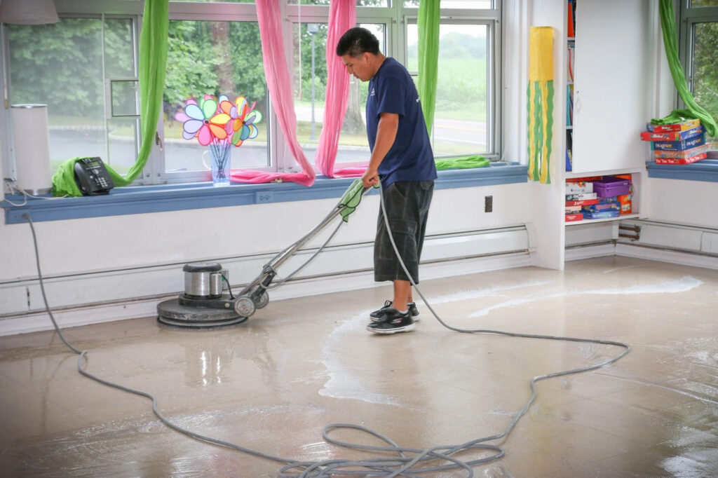 Floor buffing technician in colorful classroom in Campbell, CA