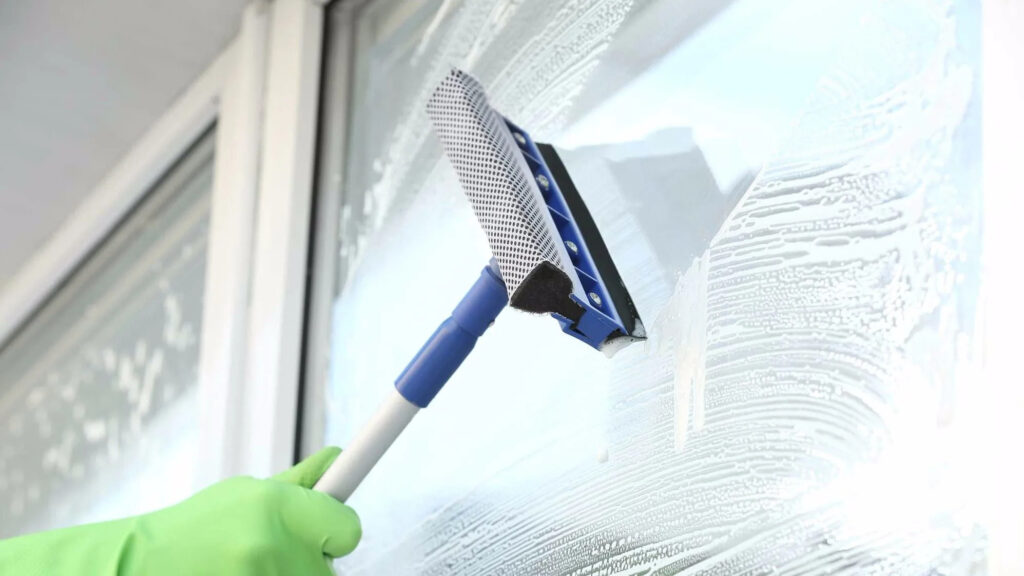Squeegee window cleaning technique on glass in Campbell, CA