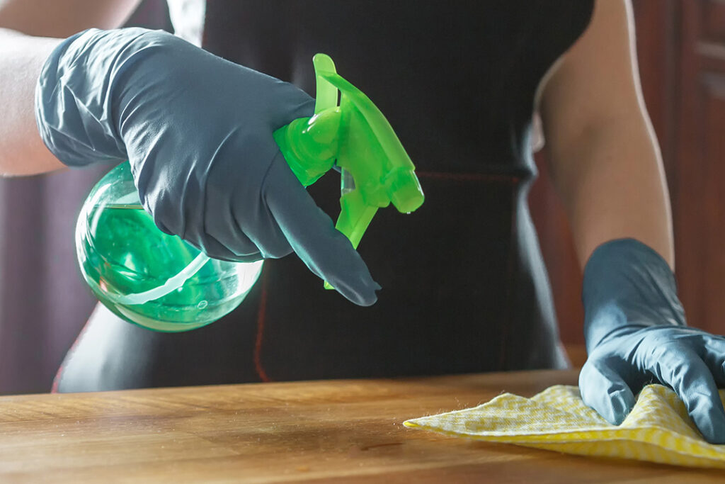 Eco-friendly cleaning San Jose CA green solution sprayed on wood surface