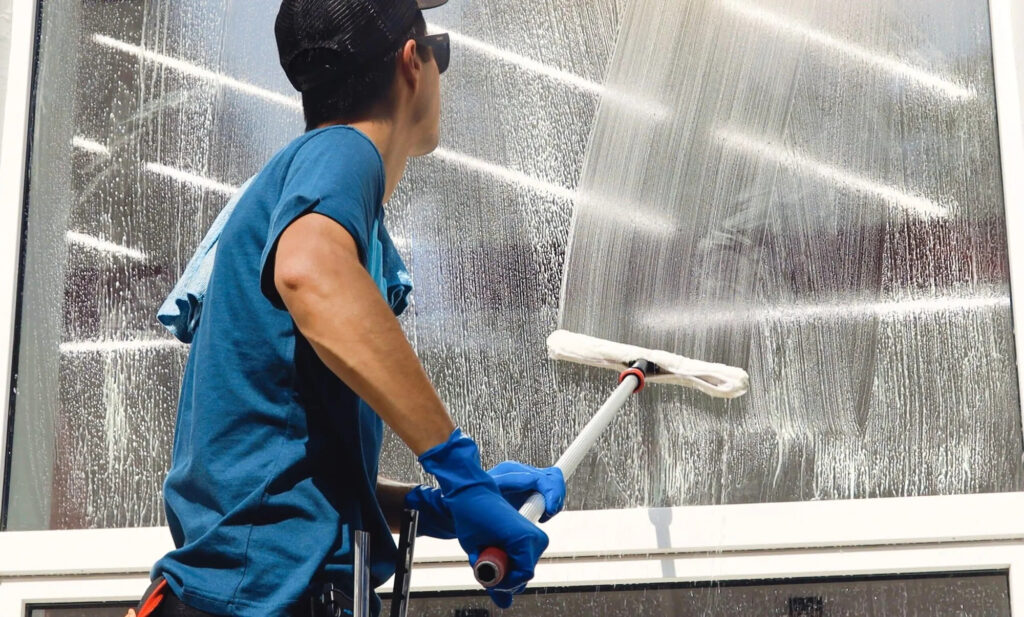 Los Gatos, CA window cleaner squeegeeing large storefront glass